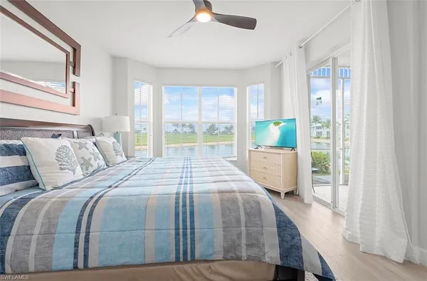 a bedroom with a bed and a large window