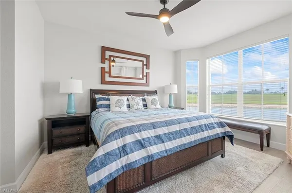 a bedroom with a bed and a large window