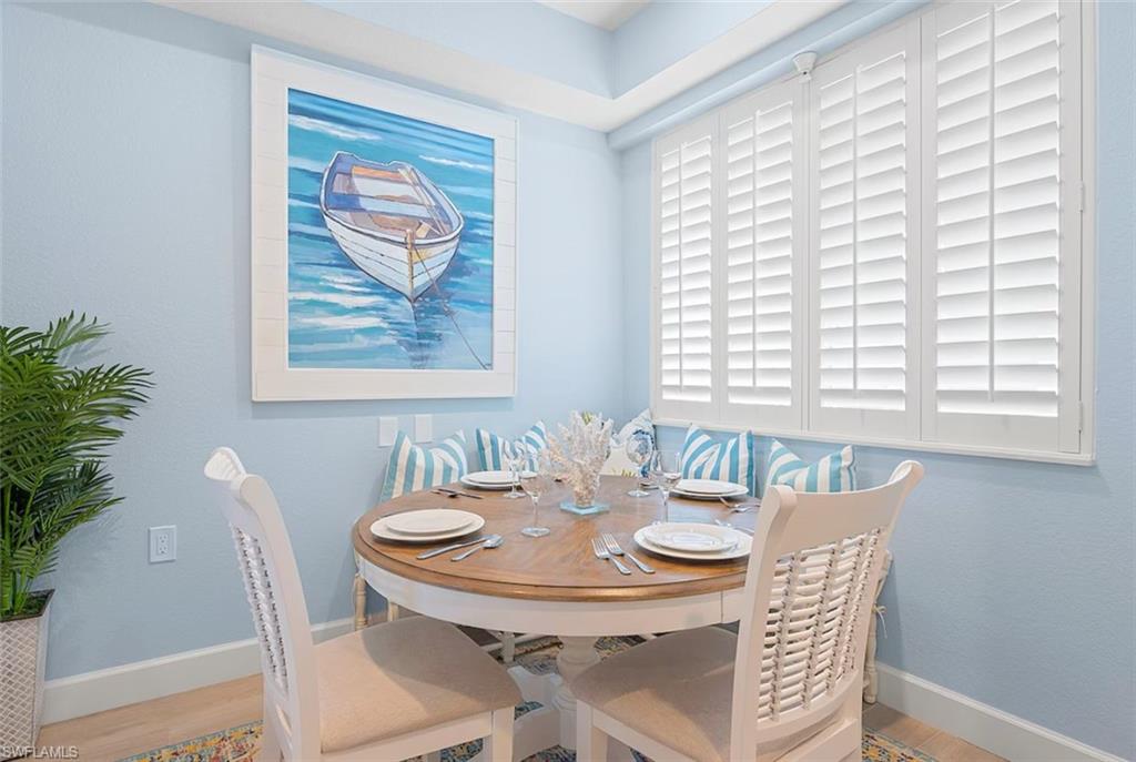 7915 Mahogany Run Lane, Unit 1114 Naples, FL 34113 - Photo 10 of 18 a view of a dining room with furniture and window
