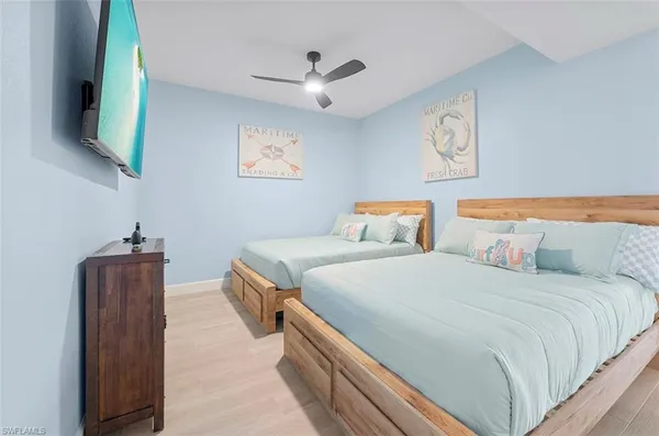 a bedroom with bed and wooden floor
