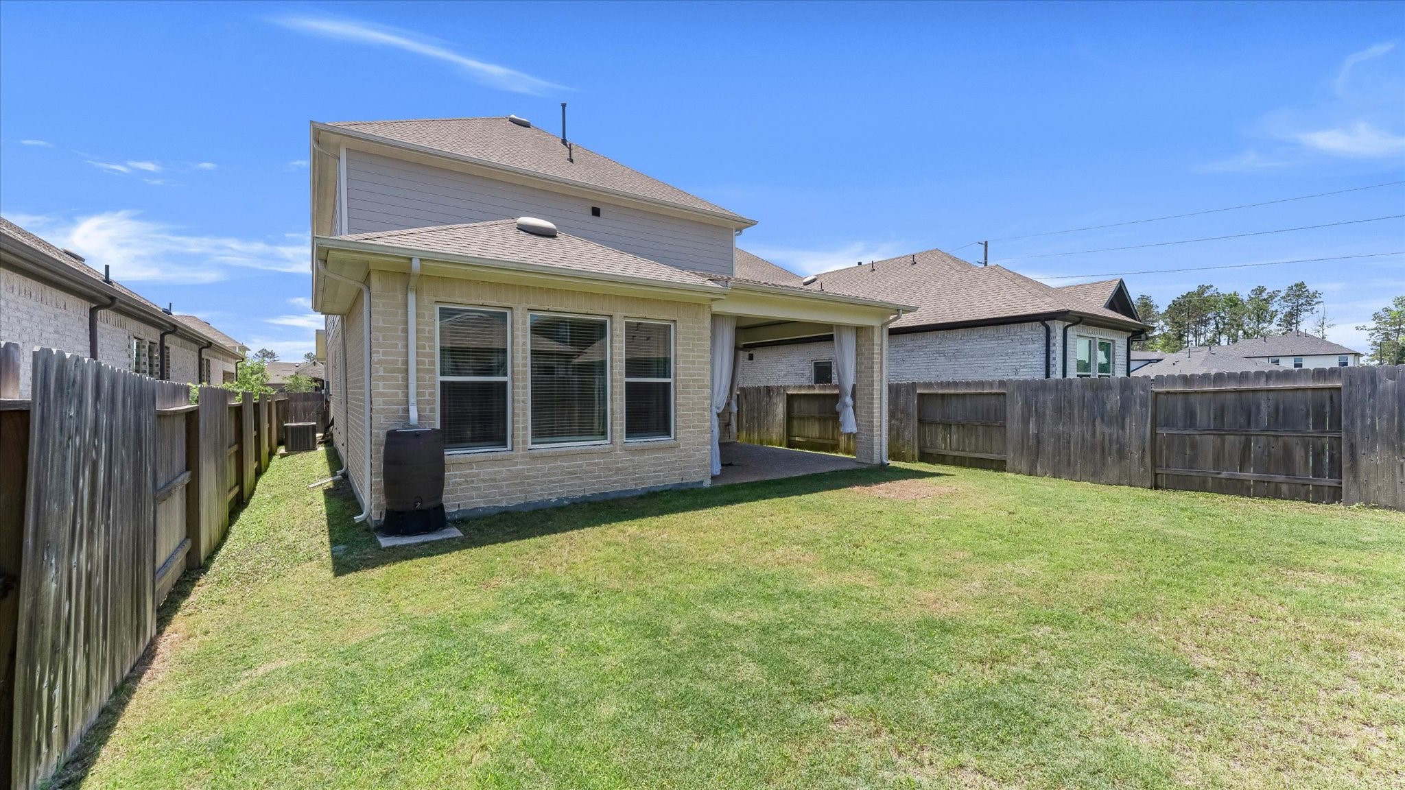 15607 Rising Wren Court Conroe, TX 77302 - Photo 38 of 40 a view of a house with wooden floor and a yard
