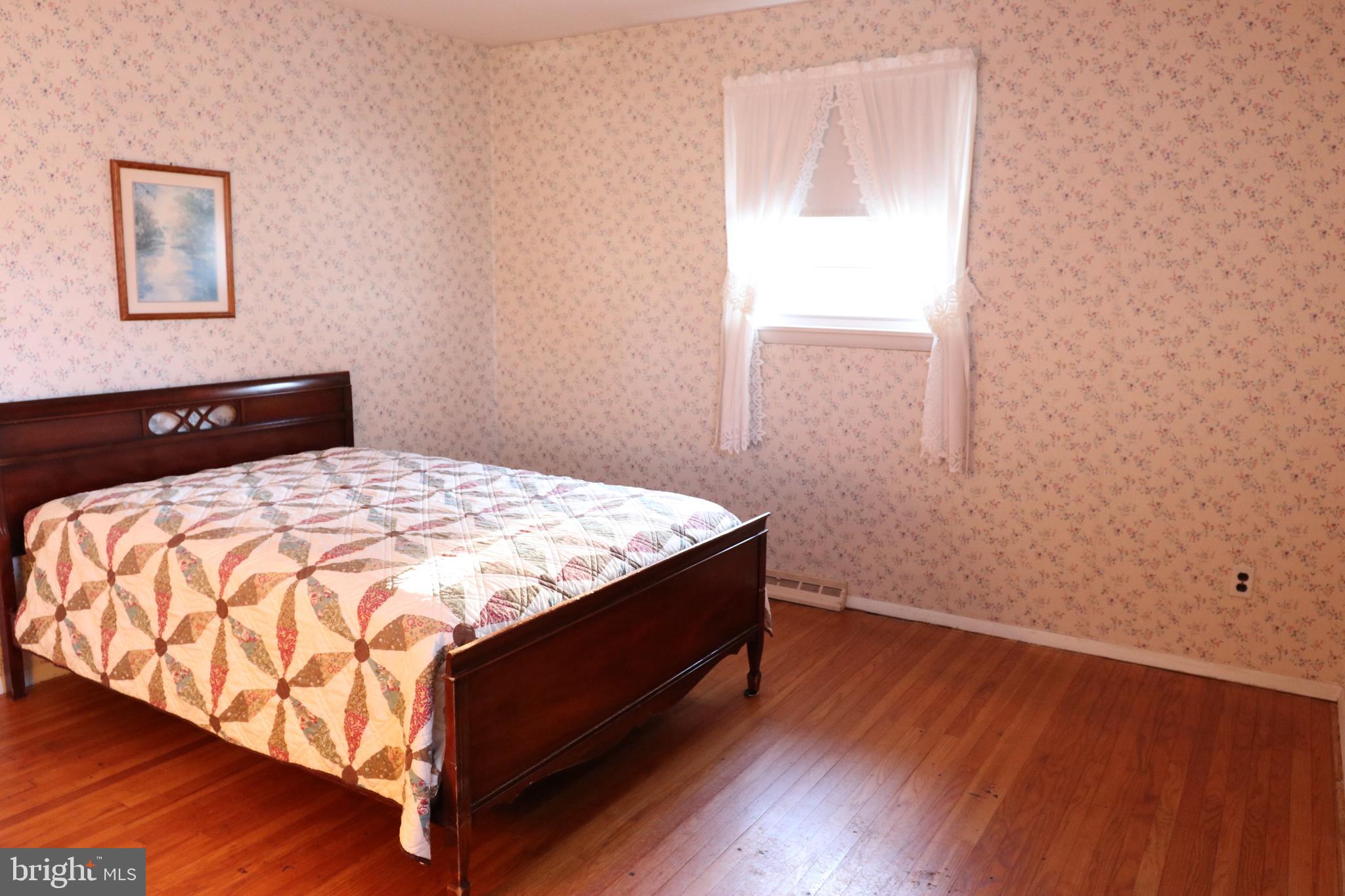 14 Olney Circle Haddonfield, NJ 08033 - Photo 12 of 21 a bedroom with a bed and wooden floor