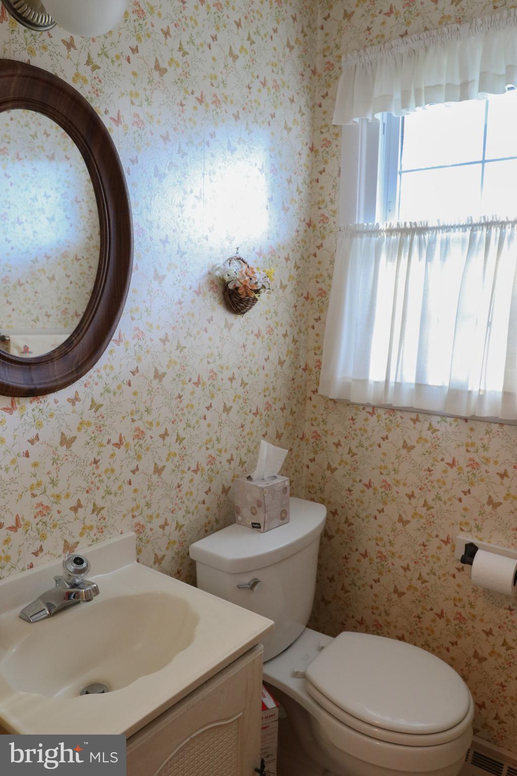 14 Olney Circle Haddonfield, NJ 08033 - Photo 16 of 21 a bathroom with a sink and a mirror
