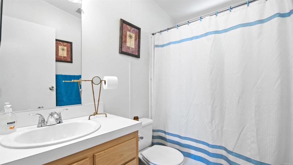1455 Alturas Road, Unit 55 Fallbrook, CA 92028 - Photo 19 of 31 a bathroom with a sink and a mirror