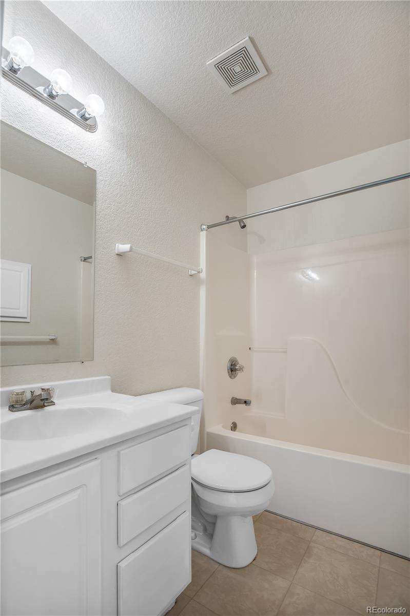 11690 West 46th Avenue Wheat Ridge, CO 80033 - Photo 21 of 33 a bathroom with a sink a toilet and shower
