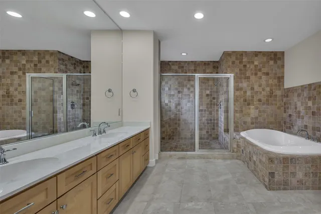 a spacious bathroom with a double vanity sink mirror and shower