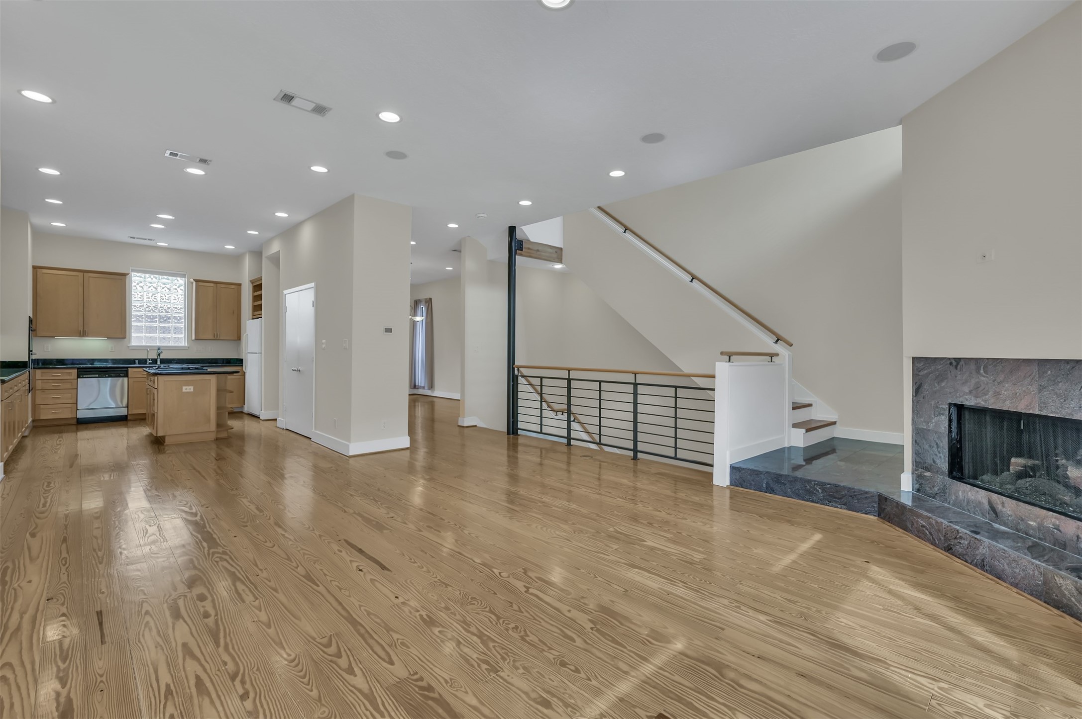 1503 California Street, Unit B Houston, TX 77006 - Photo 5 of 23 a view of a living room a kitchen and a fireplace
