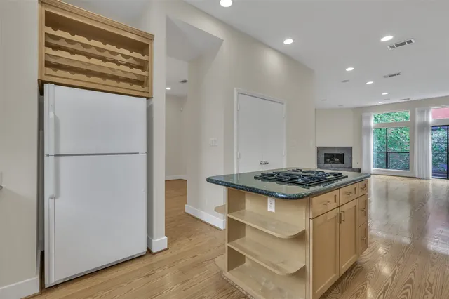 a kitchen with granite countertop a stove and a refrigerator