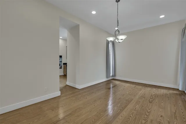 a view of a room with wooden floor