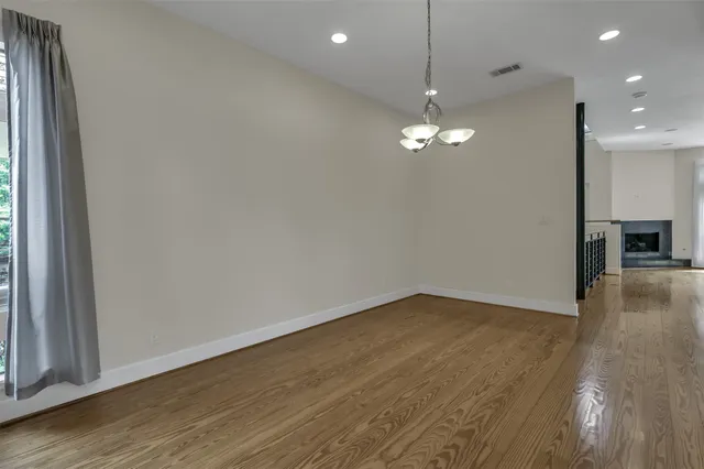 a view of a room a ceiling fan and hardwood floor