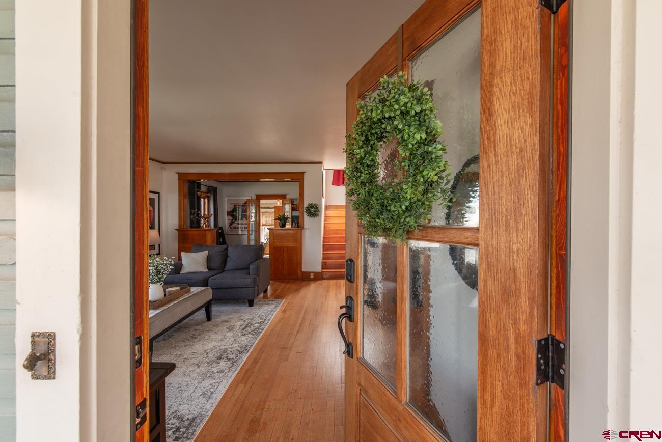 746 South 2nd Street Montrose, CO 81401 - Photo 5 of 43 a hallway with a dining table and chairs