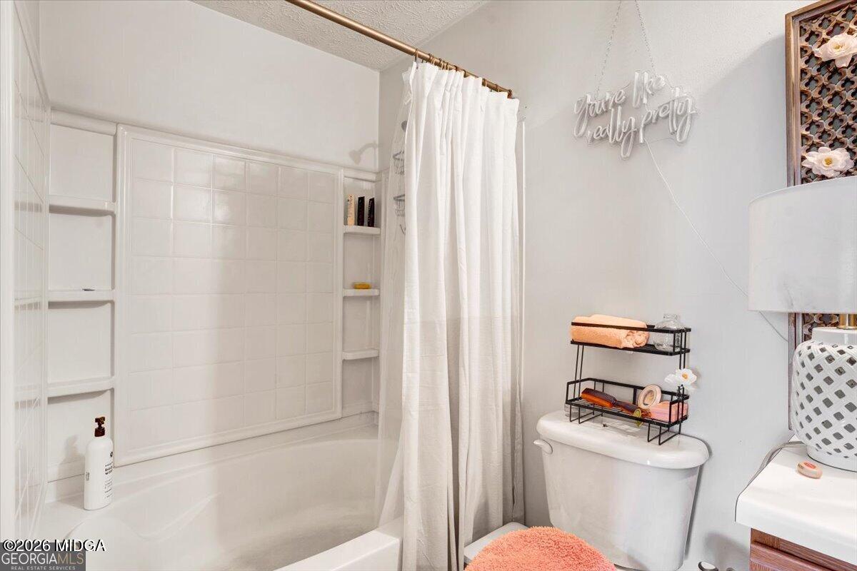 8301 Par 4 Way Lithonia, GA 30038 - Photo 3 of 4 a white toilet sitting next to a bathroom sink