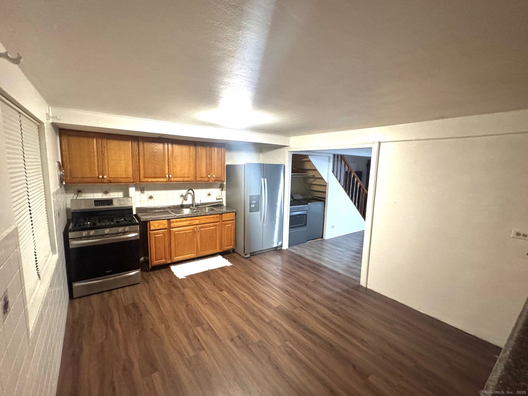 a kitchen with stainless steel appliances a refrigerator and a stove top oven