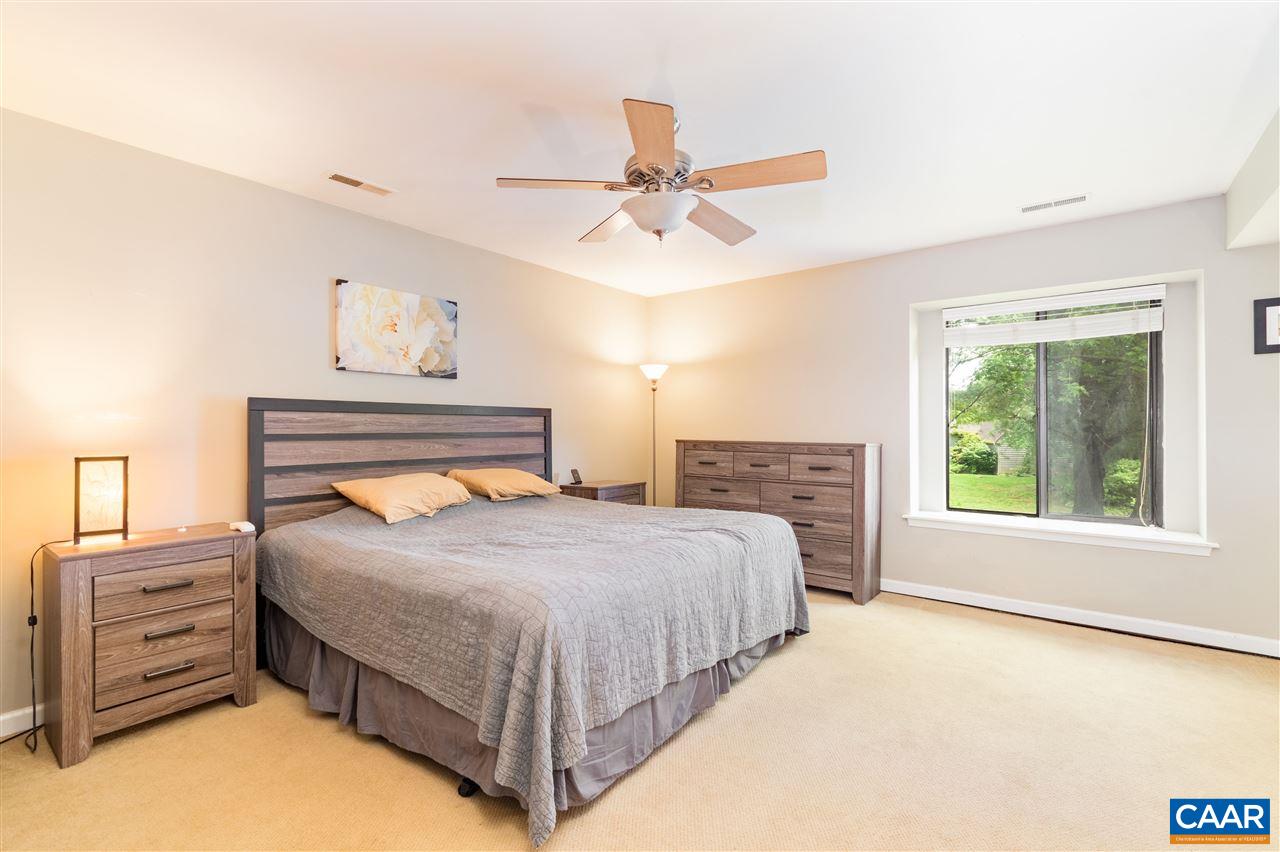1124 Amber Ridge Road Charlottesville, VA 22901 - Photo 13 of 30 a bedroom with a bed and a chandelier