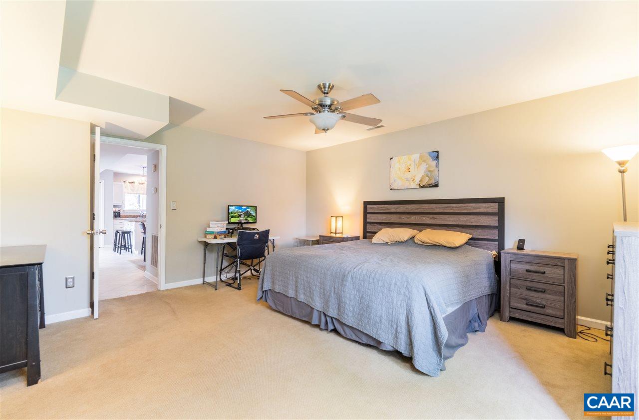 1124 Amber Ridge Road Charlottesville, VA 22901 - Photo 14 of 30 a bedroom with a bed dresser and a dining table