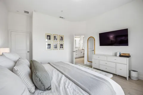 a bedroom with a bed and a flat screen tv