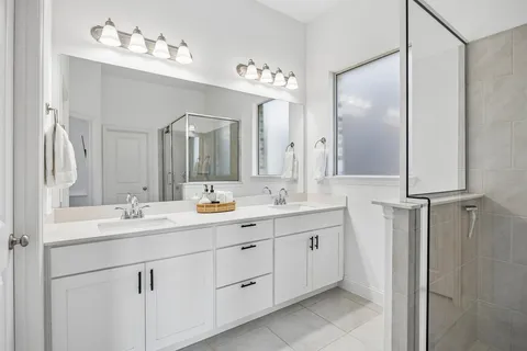 a bathroom with a double vanity sink and a mirror