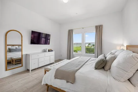 a bedroom with a bed and a flat screen tv