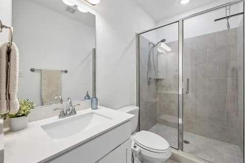 a bathroom with a sink toilet and shower