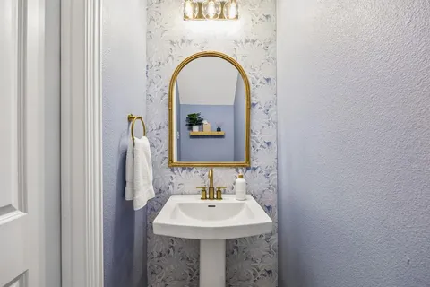 a bathroom with a sink and a mirror