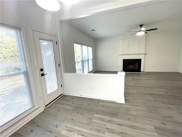 wooden floor in an empty room with a fireplace
