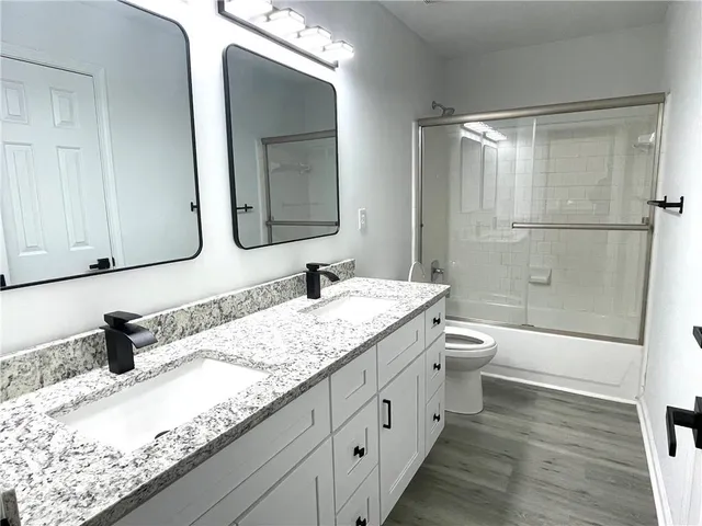 a bathroom with a double vanity sink and mirror