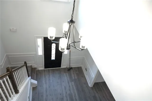 a view of entryway and hall with wooden floor