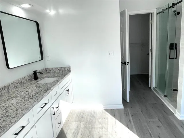 a bathroom with a glass door shower