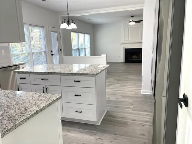 a view of living room with granite countertop furniture and fireplace