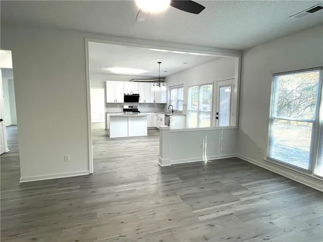 a view of kitchen with sink and wooden floor