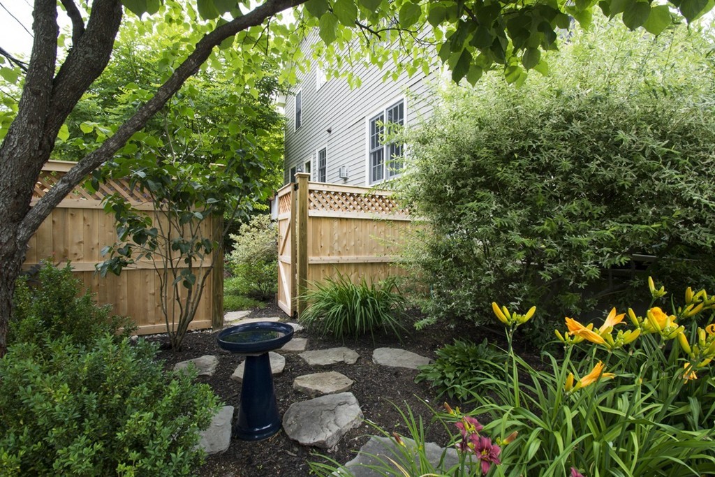 15 Cerina Road, Unit 15 Boston, MA 02130 - Photo 24 of 28 a view of a garden with a bench