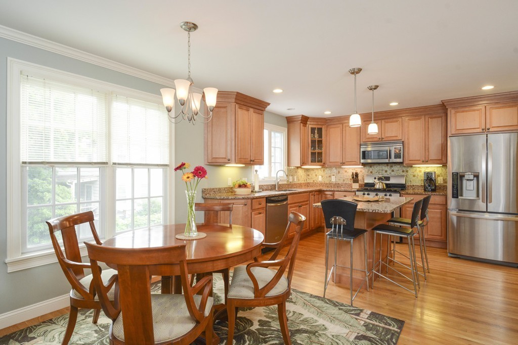 15 Cerina Road, Unit 15 Boston, MA 02130 - Photo 6 of 28 a dining room kitchen with stainless steel appliances kitchen island granite countertop a dining table chairs and granite counter tops