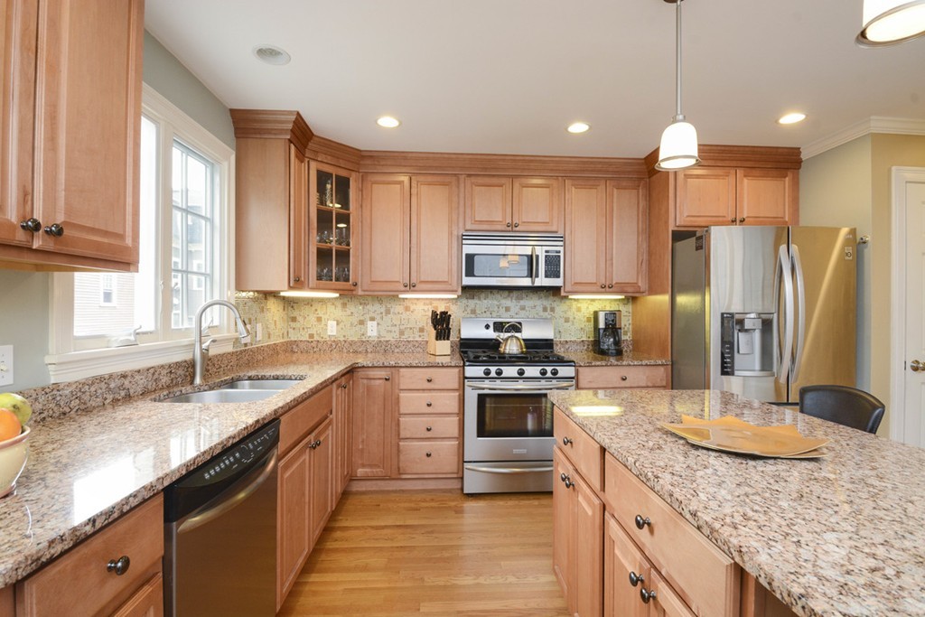 15 Cerina Road, Unit 15 Boston, MA 02130 - Photo 8 of 28 a kitchen with stainless steel appliances granite countertop a sink stove and refrigerator