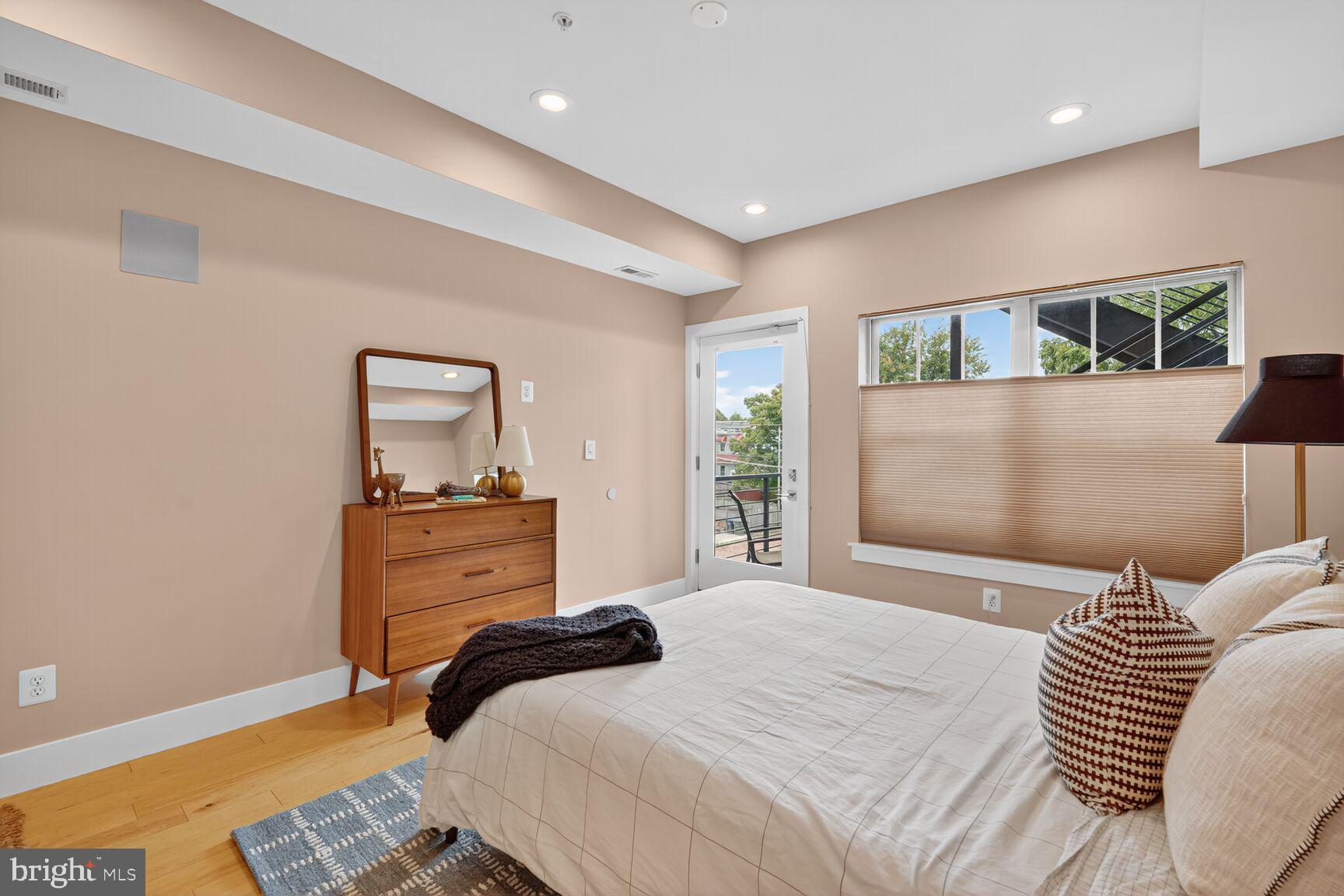 816 Kennedy Street Northwest, Unit 3 Washington, DC 20011 - Photo 6 of 9 a bedroom with a bed and a mirror