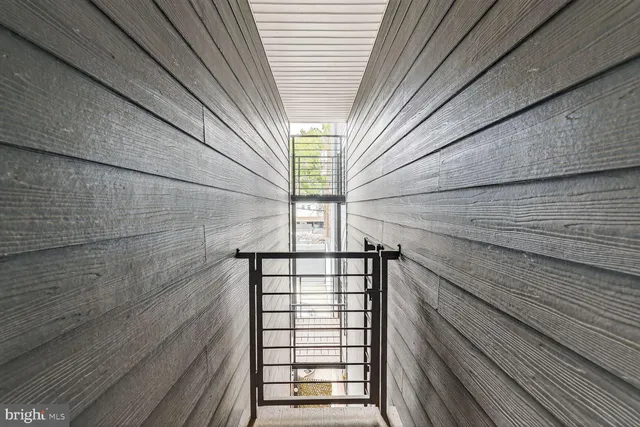 a view of a balcony with wooden floor and iron fence