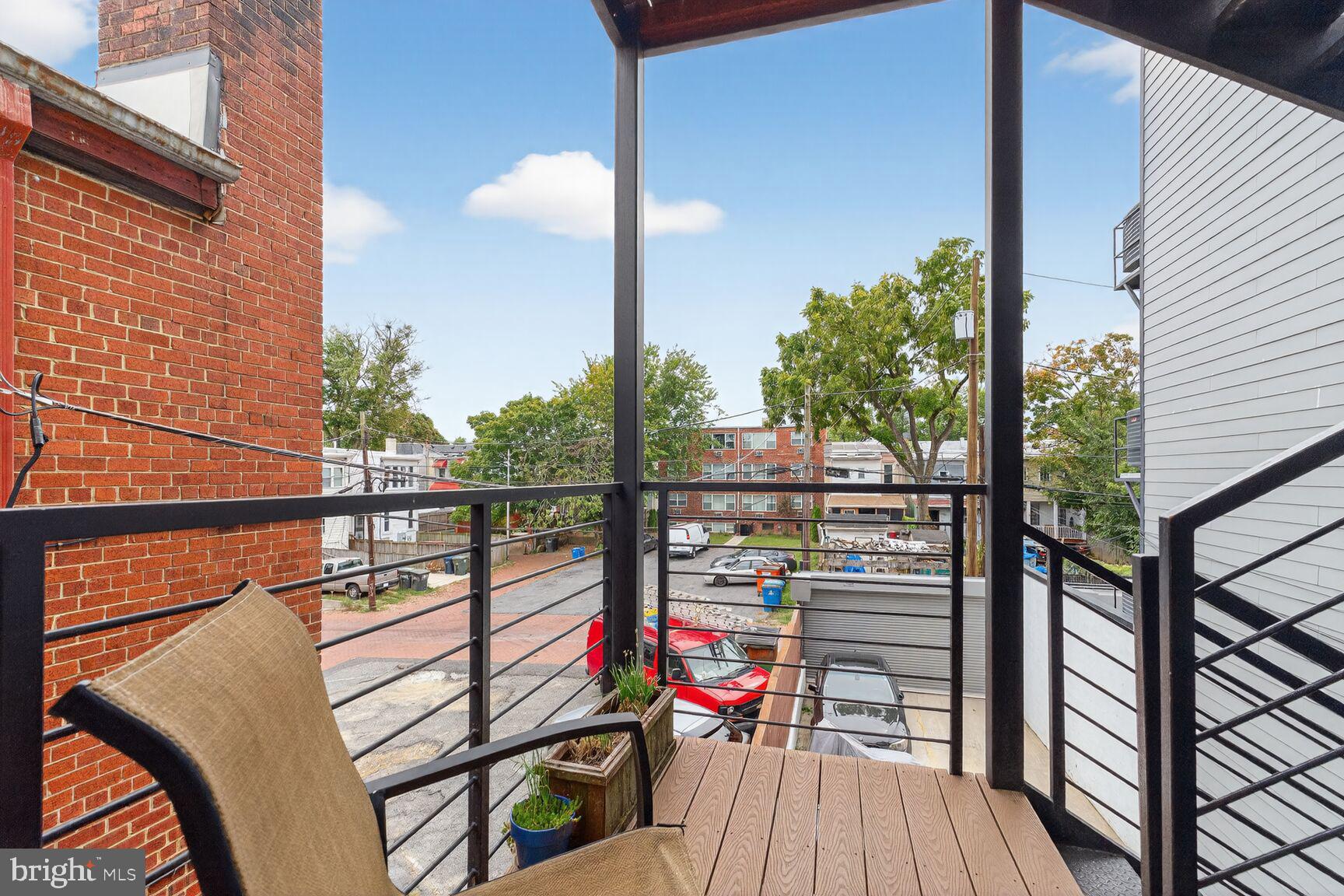 816 Kennedy Street Northwest, Unit 3 Washington, DC 20011 - Photo 9 of 9 a view of a balcony with wooden floor and iron fence