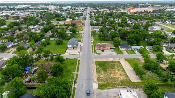 an aerial view of residential houses with yard