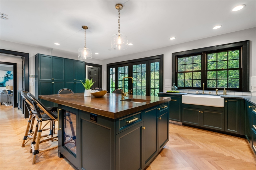 388 Warren Street Brookline, MA 02445 - Photo 11 of 34 a kitchen with stainless steel appliances granite countertop a sink a stove and a wooden floors