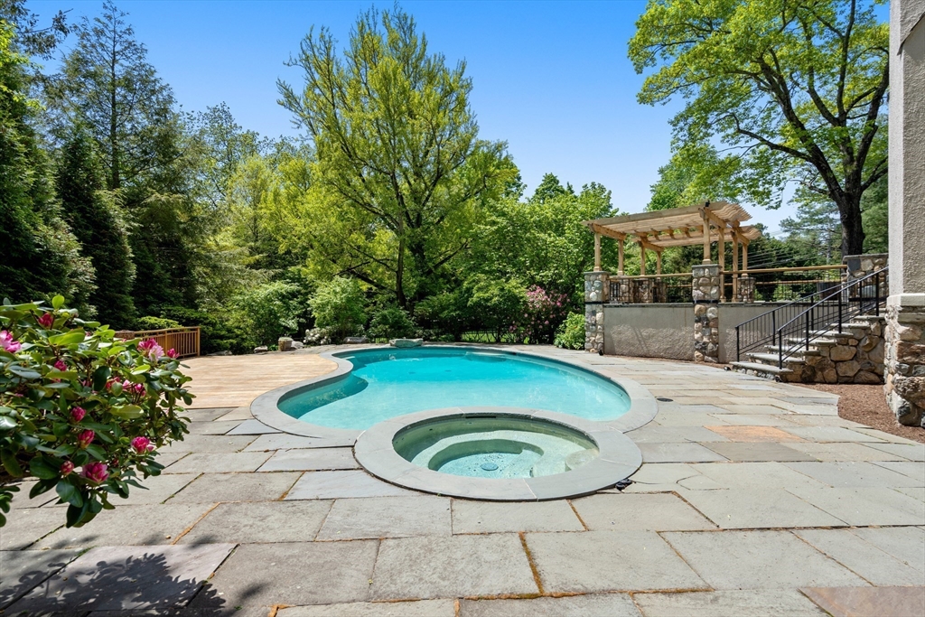 388 Warren Street Brookline, MA 02445 - Photo 28 of 34 a view of a swimming pool with a patio