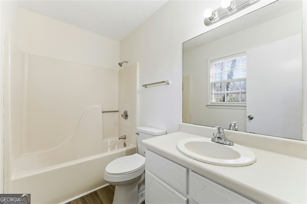 1496 Cherry Hill Road Southwest Conyers, GA 30094 - Photo 16 of 20 a bathroom with a sink toilet a mirror and shower