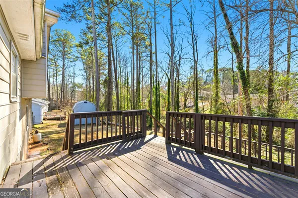 a view of balcony with wooden floor and fence