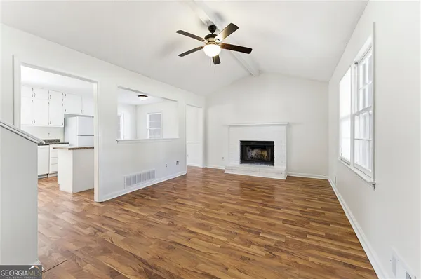 wooden floor in an empty room with a fireplace