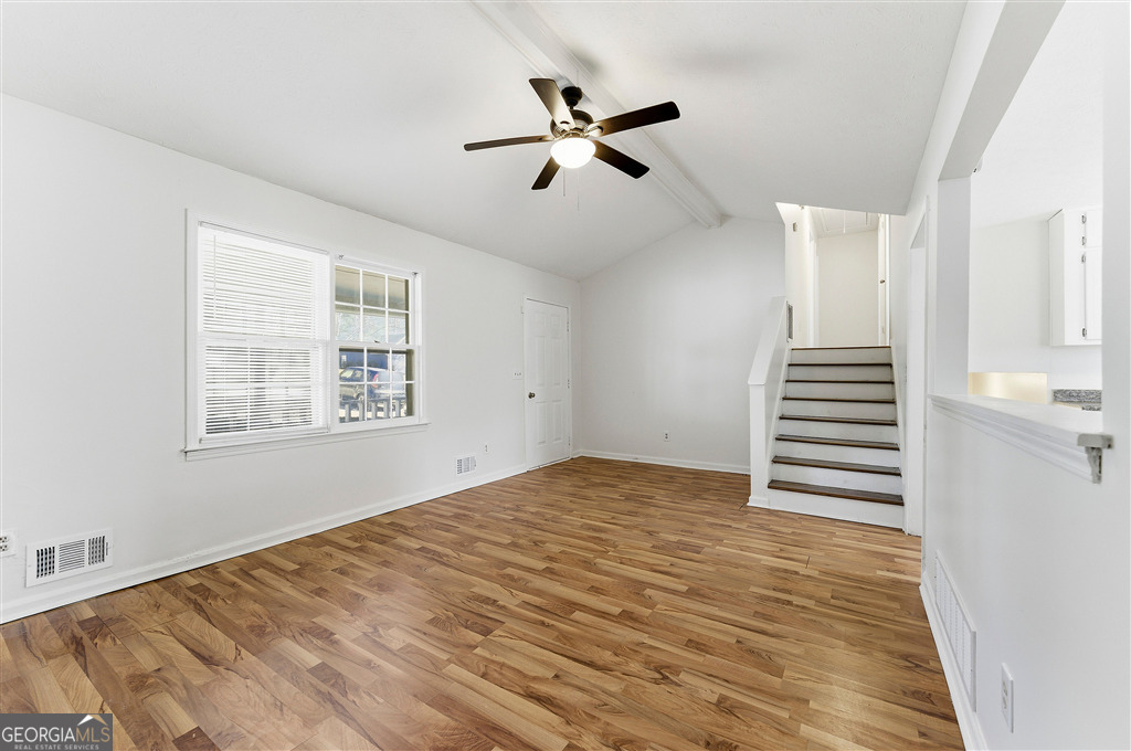 1496 Cherry Hill Road Southwest Conyers, GA 30094 - Photo 6 of 20 a view of empty room with wooden floor and fan