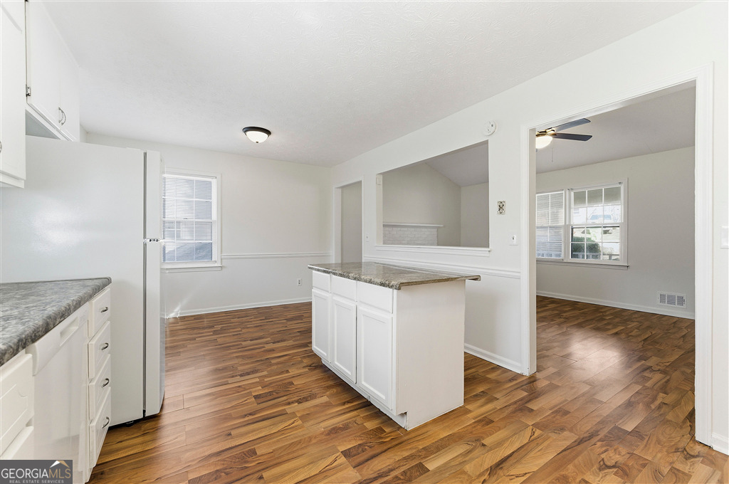 1496 Cherry Hill Road Southwest Conyers, GA 30094 - Photo 8 of 20 a kitchen with granite countertop white cabinets and white appliances