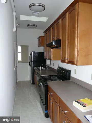 a kitchen with a stove and a refrigerator