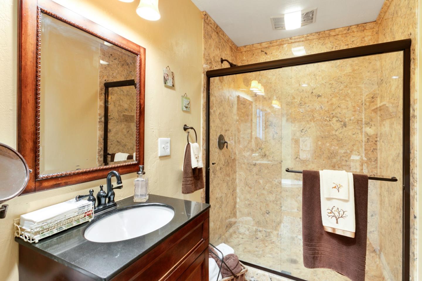 1990 Day Road Gilroy, CA 95020 - Photo 15 of 42 a bathroom with a granite countertop sink mirror and a shower