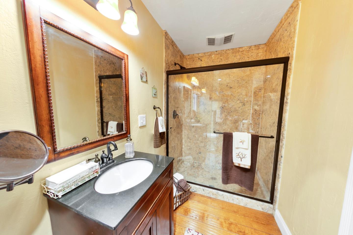 1990 Day Road Gilroy, CA 95020 - Photo 36 of 42 a bathroom with a sink a mirror and a shower