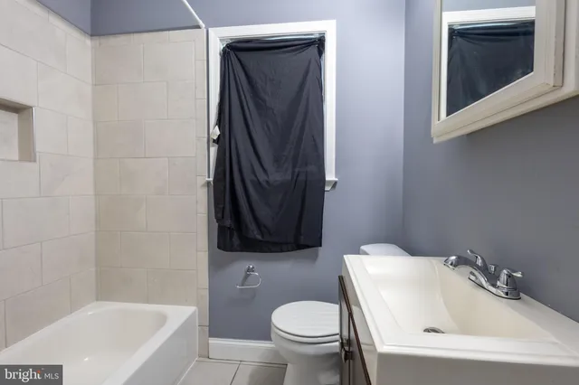 a bathroom with a sink toilet and bathtub