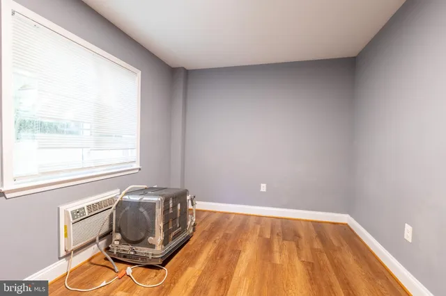a view of a room with wooden floor and windows
