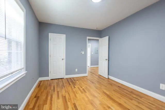 a view of a room with wooden floor and bathroom